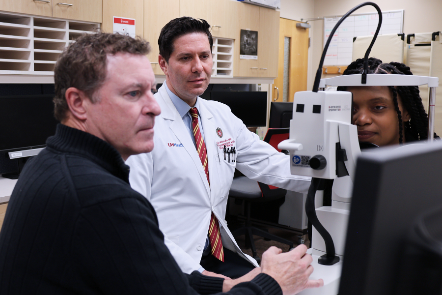 CERU's Chris Smith and Dr. Mititelu screen Nicole Boone's eyes